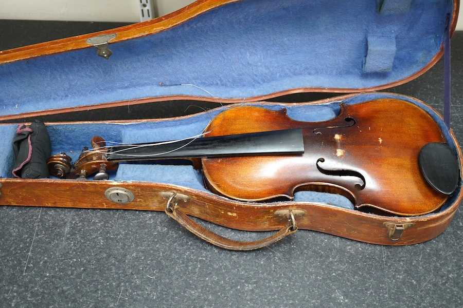 A cased violin, possibly German, body 35.5cm, in a good wooden case with canvas outer cover. Condition - fair